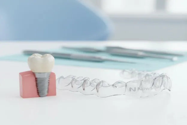 Night guard beside partial denture on dental model