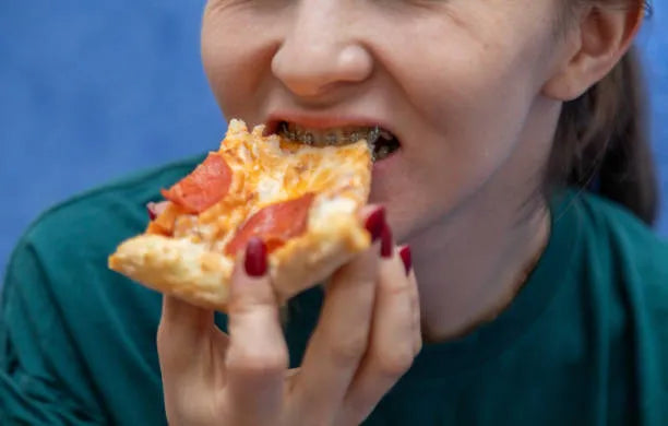 Enjoying pizza confidently with braces