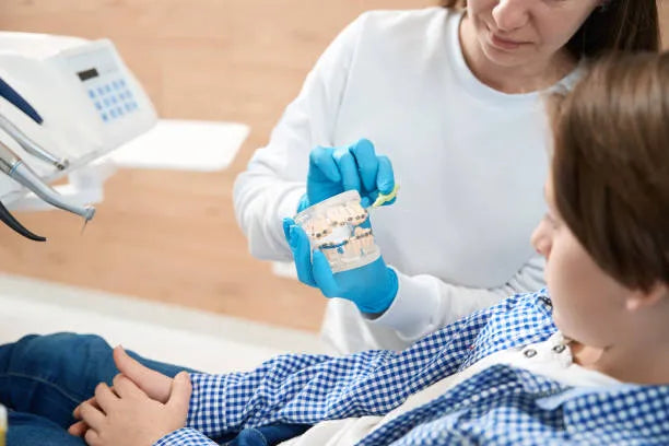 Orthodontist explaining bite correction with retainers to a patient.