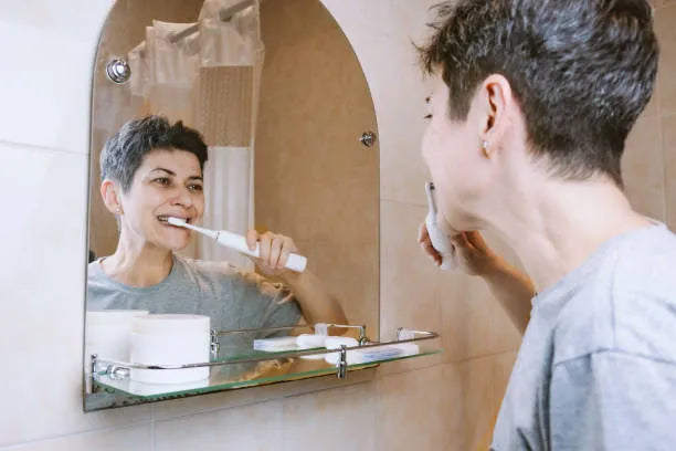Person brushing teeth with an electric toothbrush