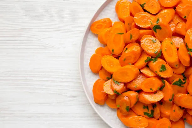 Sliced and cooked soft carrots on a plate as a braces-friendly option