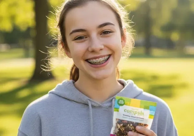 Teen smiling with braces while holding a small snack bag