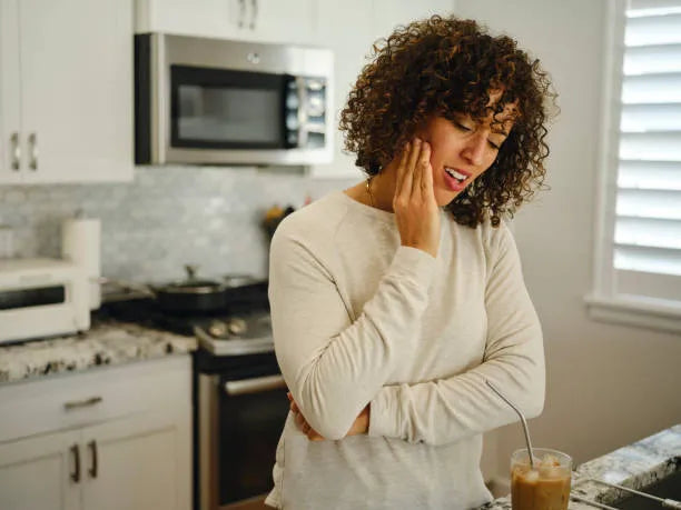 Woman feeling mild jaw soreness from night guard